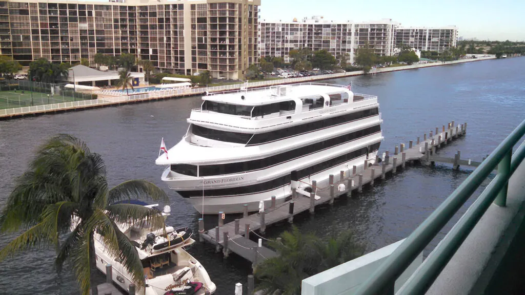a large white boat docked at a pier