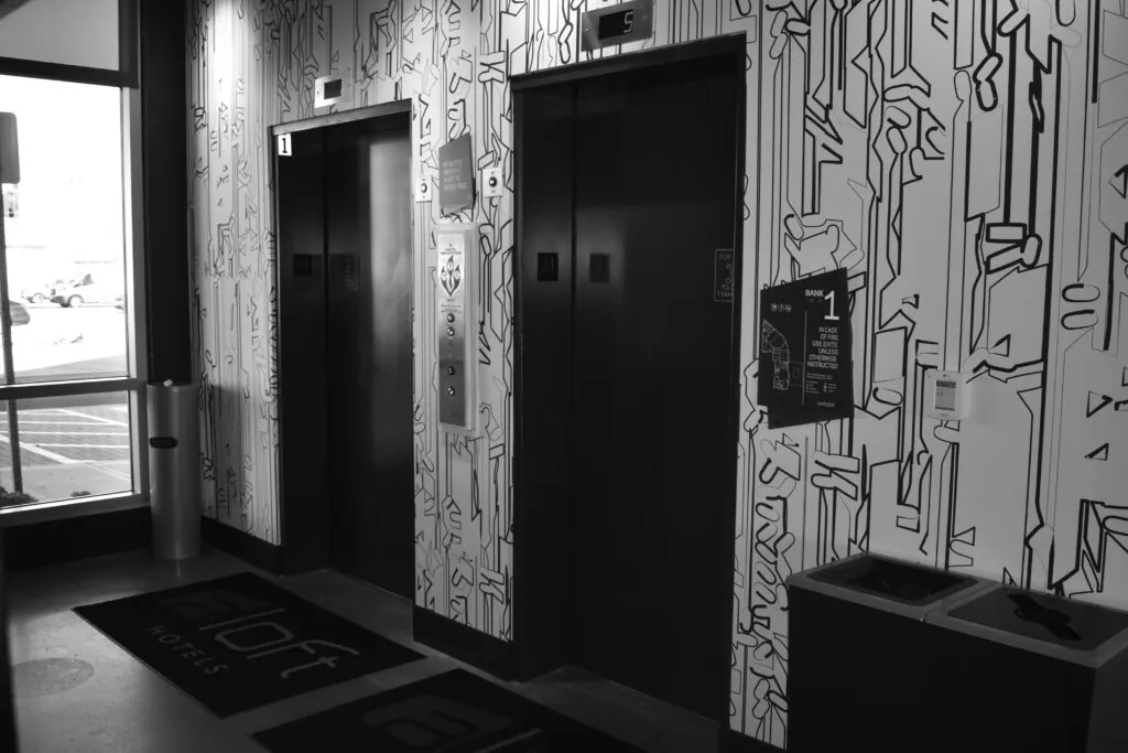 a black and white photo of a public restroom