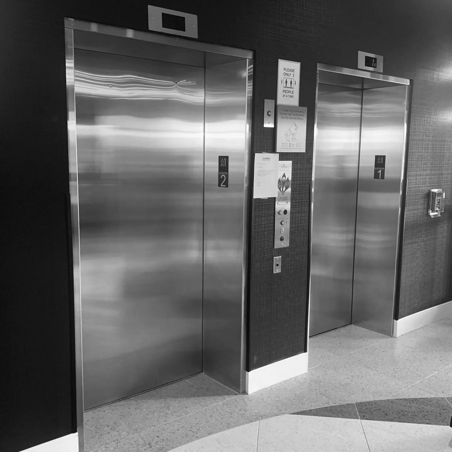 a black and white photo of a public restroom