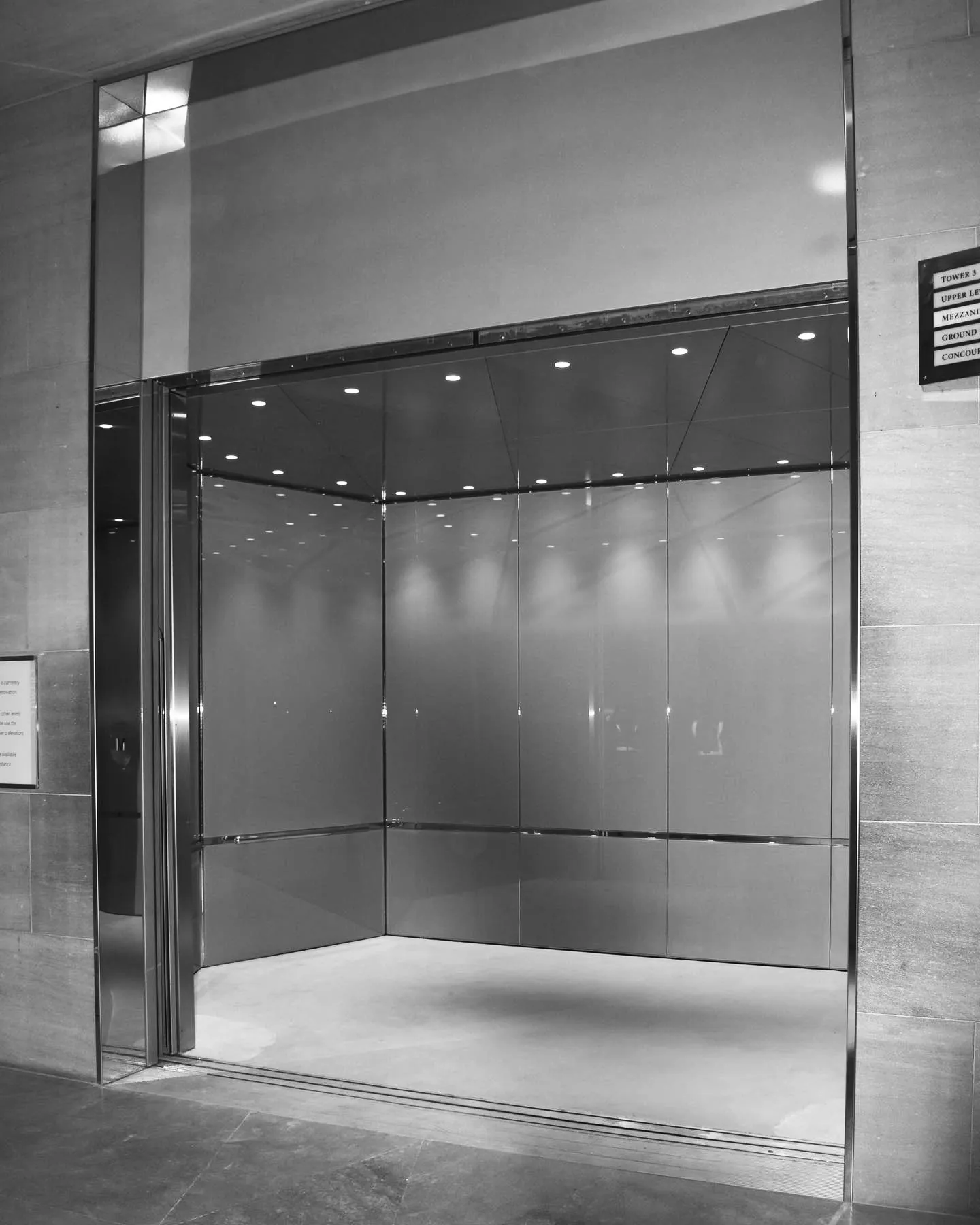 an empty room with a glass door and a sign on the wall