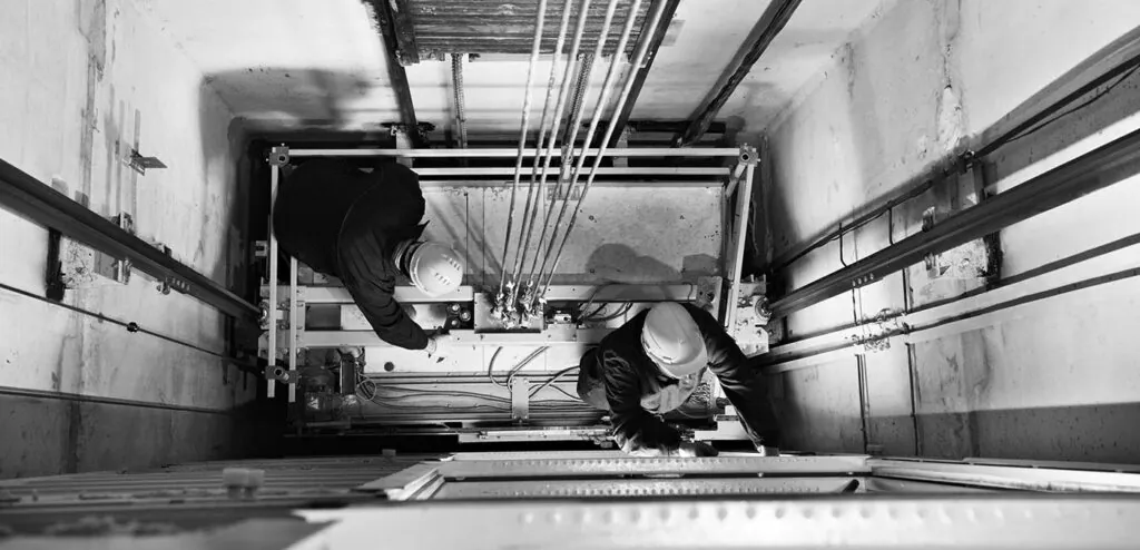 a black and white photo of a person in a truck