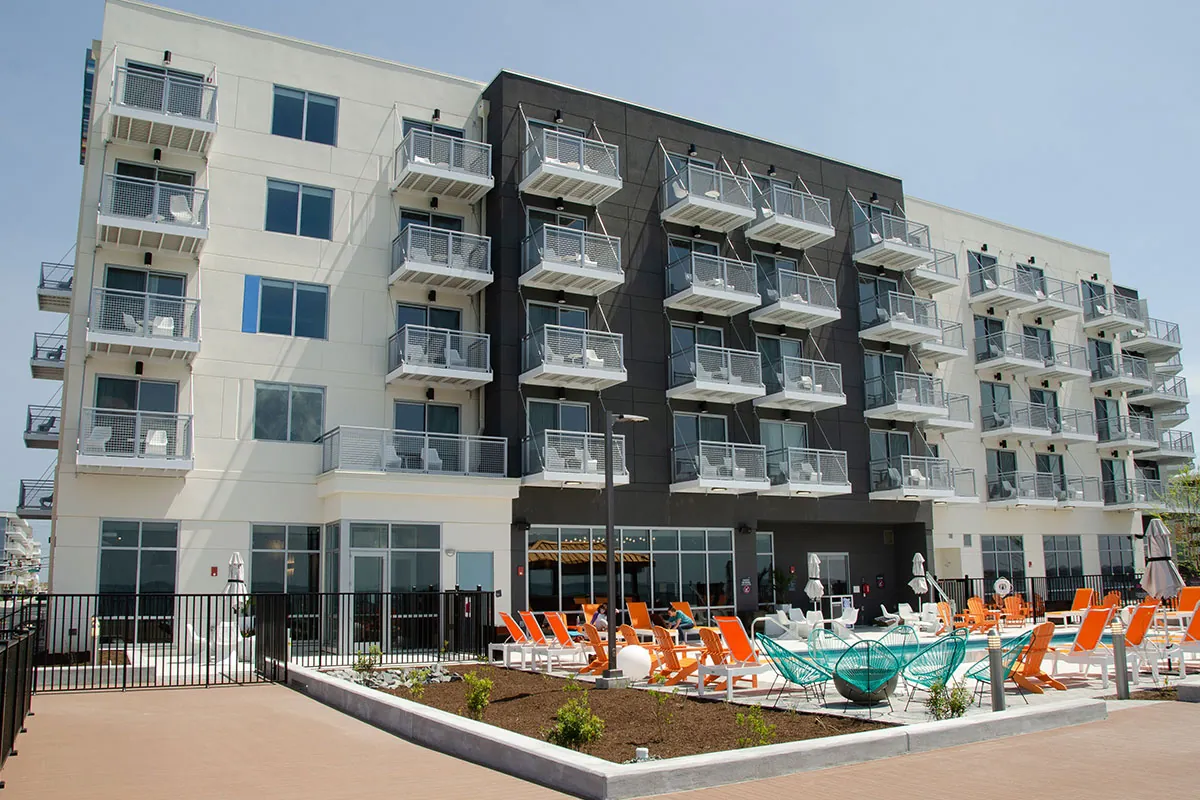 an apartment building with orange chairs in front of it