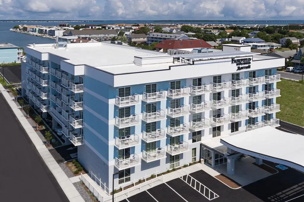 an aerial view of a hotel and parking lot