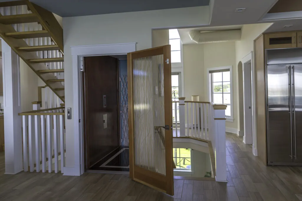 a large open floor plan with a staircase leading to a kitchen