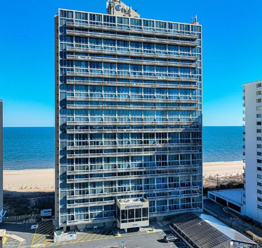 a tall building next to the beach