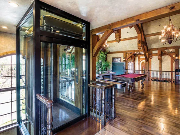 a large room with a pool table and a chandelier
