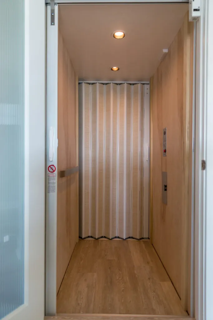 a narrow hallway with a sliding glass door