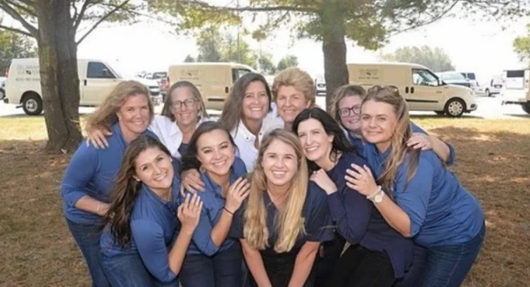 a group of women standing next to each other